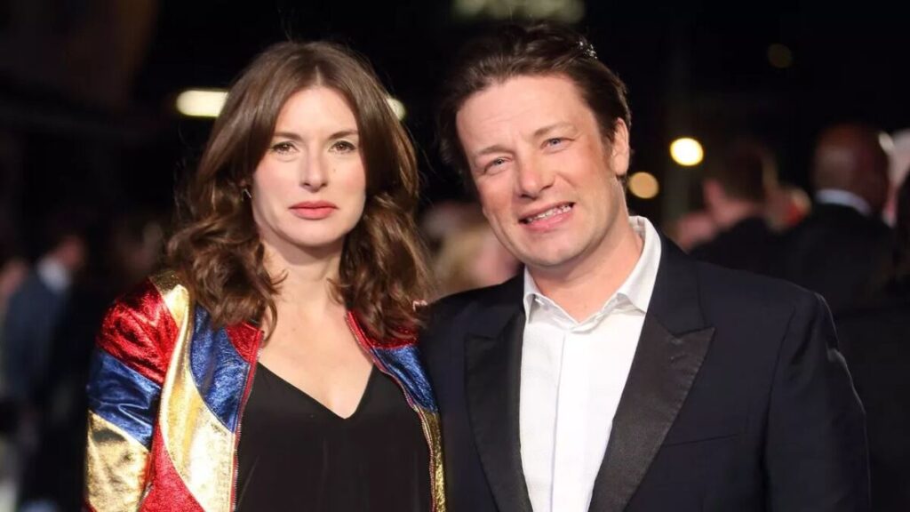 Jamie Oliver and his wife Juliette Norton smiling together at a public event.