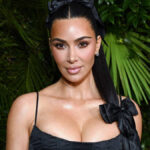 Kim Kardashian attending a red carpet event in 2025, wearing a designer gown.