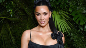 Kim Kardashian attending a red carpet event in 2025, wearing a designer gown.