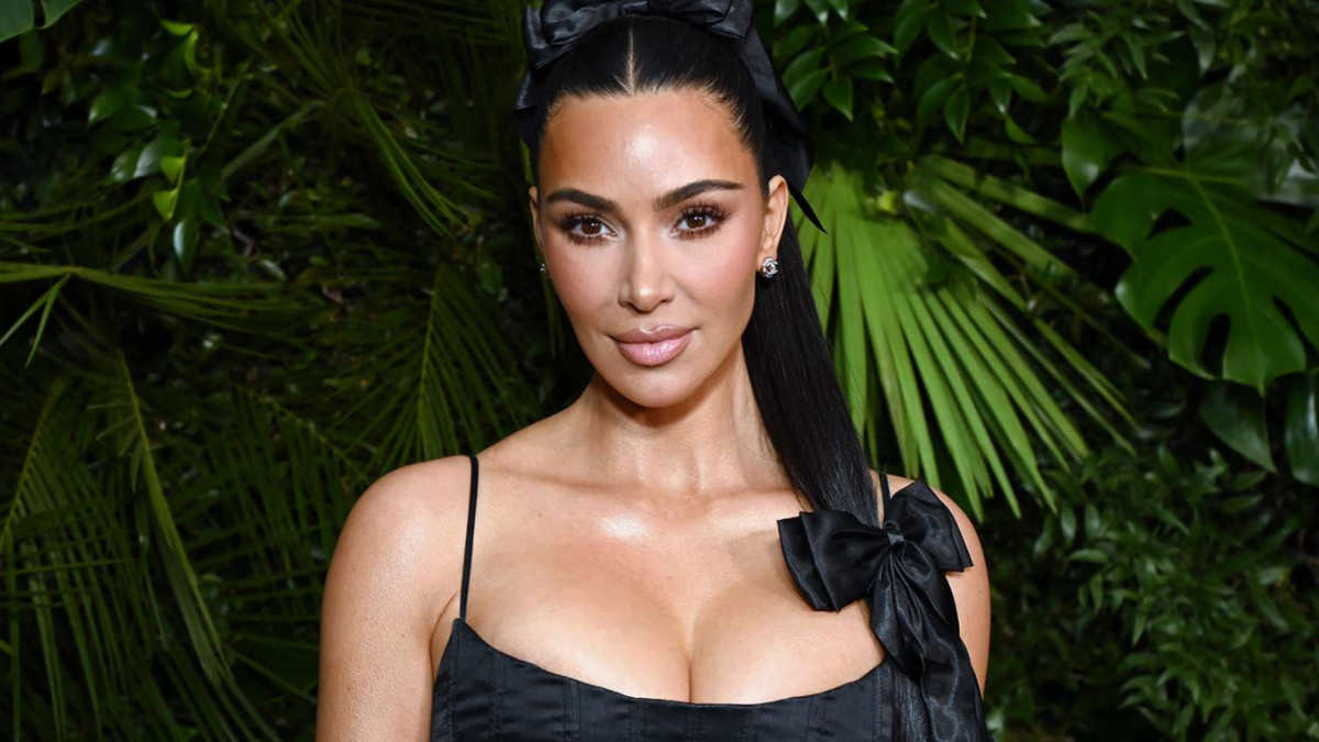 Kim Kardashian attending a red carpet event in 2025, wearing a designer gown.