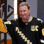 Mario Lemieux skating during an NHL game with the Pittsburgh Penguins, wearing number 66 jersey.