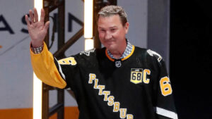 Mario Lemieux skating during an NHL game with the Pittsburgh Penguins, wearing number 66 jersey.