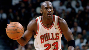 Michael Jordan wearing a Chicago Bulls jersey, mid-air during a slam dunk