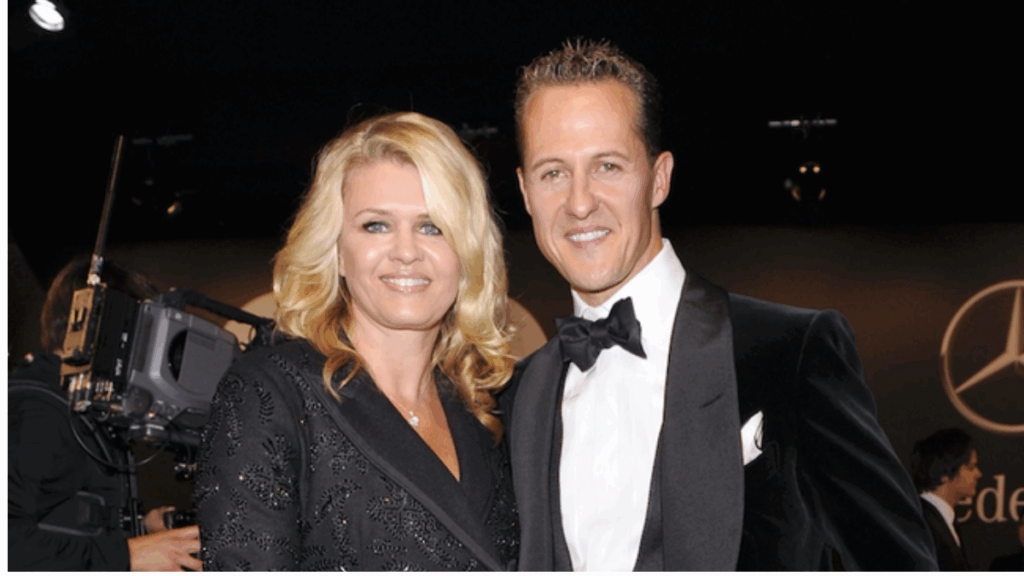 Michael Schumacher and his wife Corinna Schumacher smiling together at a event.