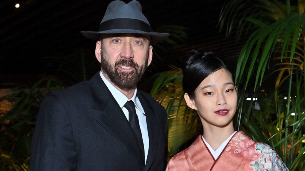Nicolas Cage and his wife Riko Shibata posing together at a red carpet event