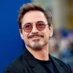 Robert Downey Jr. in 2025, wearing a tailored suit and sunglasses at a red carpet event