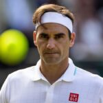 Roger Federer serving during a professional tennis match