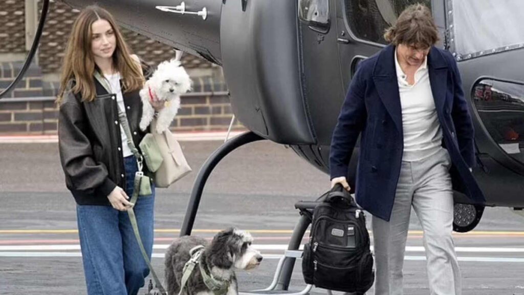 Tom Cruise and Ana de Armas stepping out of a helicopter with dogs, February 2025