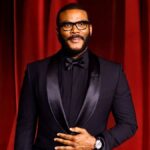 Tyler Perry at a red carpet event in 2025, wearing a tailored black suit