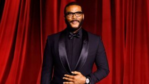 Tyler Perry at a red carpet event in 2025, wearing a tailored black suit