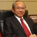 Portrait of Wichai Thongtang, Thai billionaire lawyer and investor, wearing a business suit.
