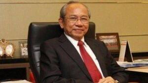 Portrait of Wichai Thongtang, Thai billionaire lawyer and investor, wearing a business suit.