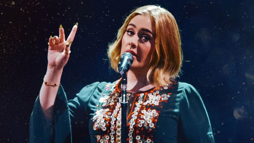 Adele performing on stage during her Las Vegas residency, showcasing the high-stakes glamour and emotional power of her record-breaking shows — a true reflection of her “High Stakes & Higher Notes” career strategy.