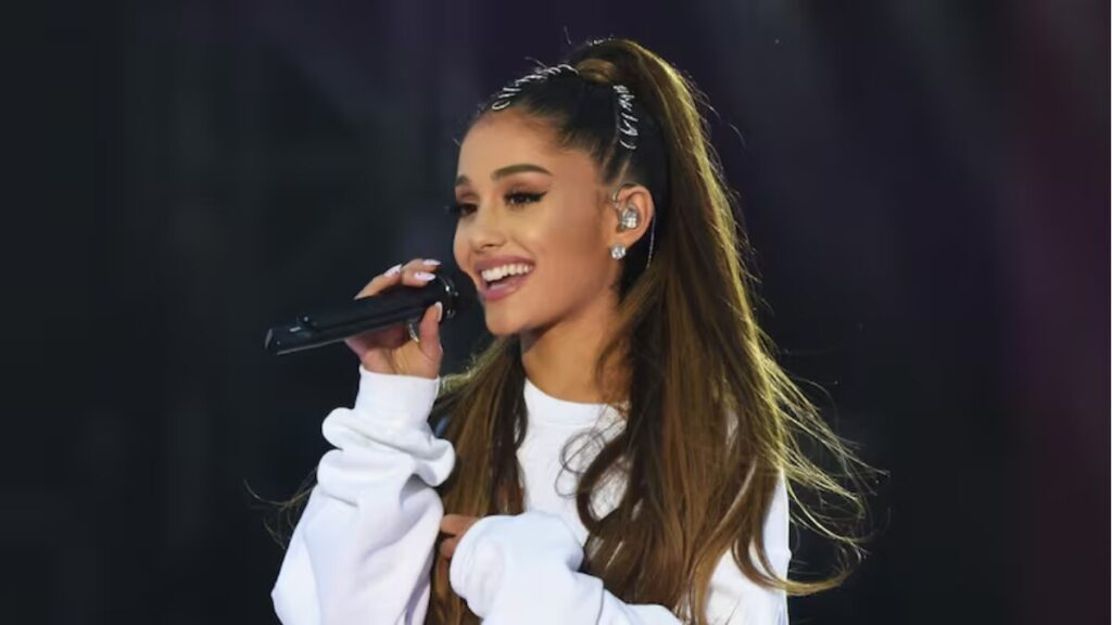 Ariana Grande in 2025 with R.E.M. Beauty branding and luxury lifestyle elements, representing her rising net worth and business success.