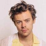 Harry Styles wearing a custom Gucci suit, highlighting his fashion collaborations and brand partnerships.