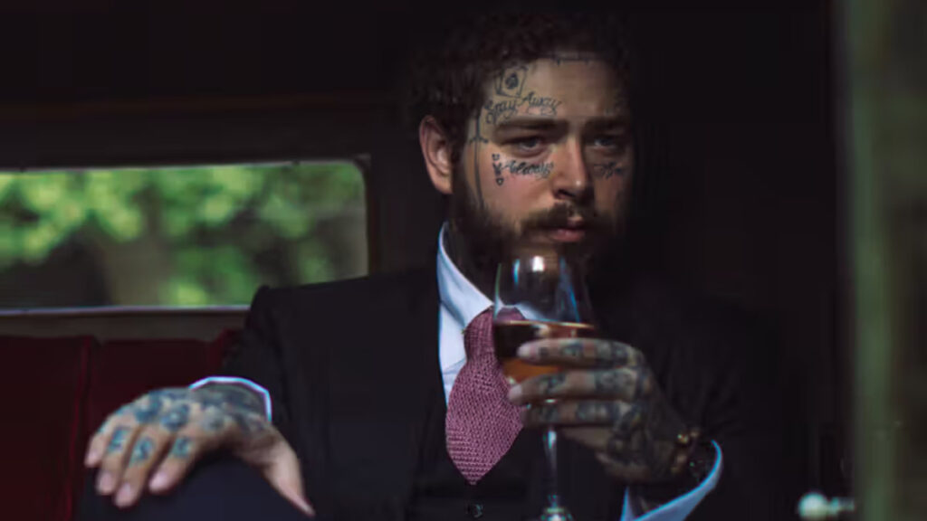 Post Malone holding a can of Grapevine Beer, a key part of his business ventures in the beverage industry