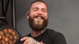Post Malone performing live during a sold-out tour, showcasing one of his major income streams.