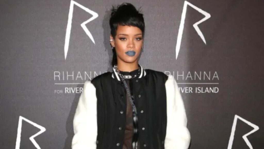 Rihanna showcasing her Super Rihanna for River Island collection on the runway, wearing a bold, streetwear-inspired outfit from the collaboration.